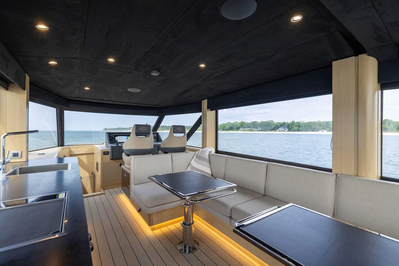 The saloon offers a spacious and modern setting with panoramic views and luxurious seating. aboard GRIT Yacht for Sale