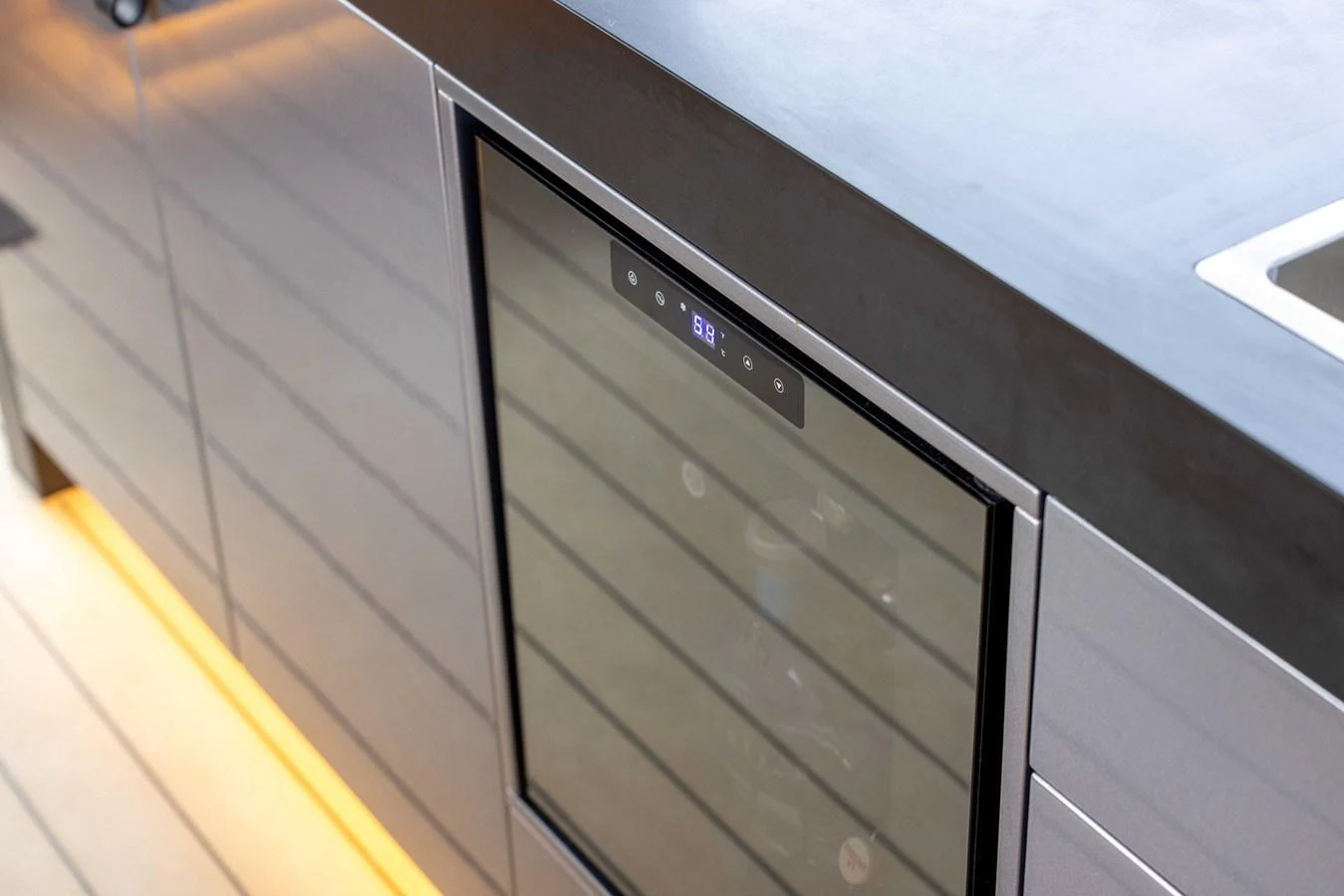 A sleek, modern galley with a built-in wine cooler and minimalist design. aboard GRIT Yacht for Sale