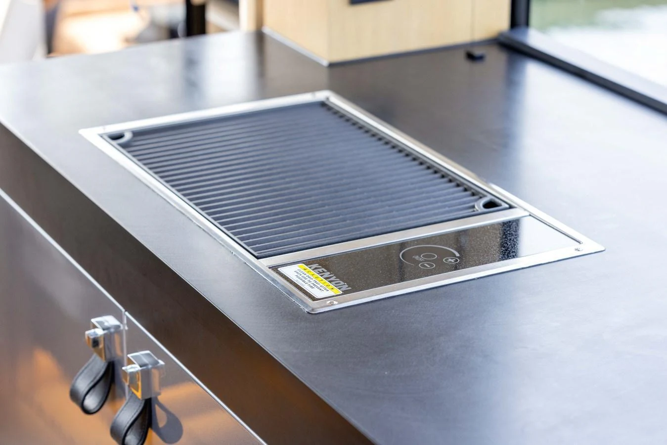 The yacht features a sleek built-in grill in the galley area. aboard GRIT Yacht for Sale