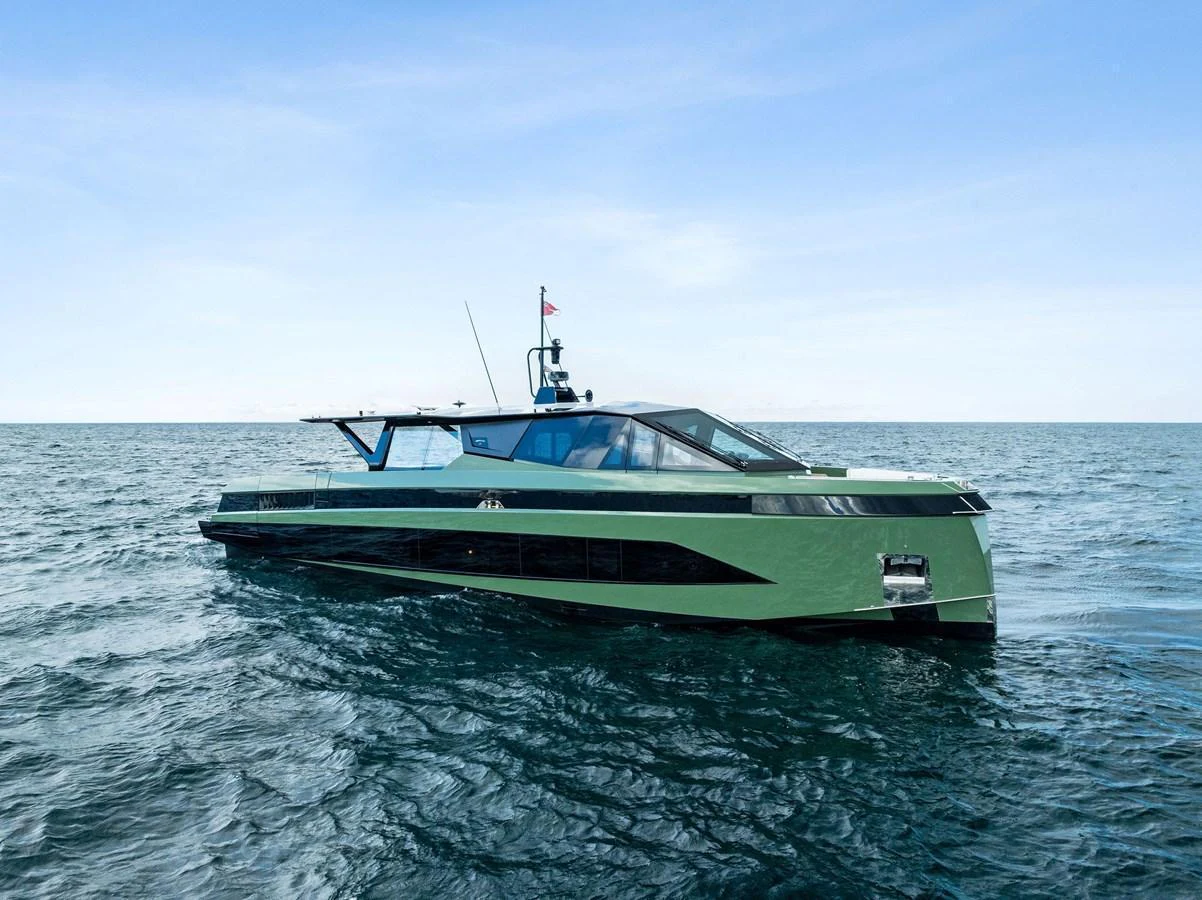 A sleek, modern yacht glides effortlessly on the open sea under a clear blue sky. aboard ANOTHER WORLD Yacht for Sale