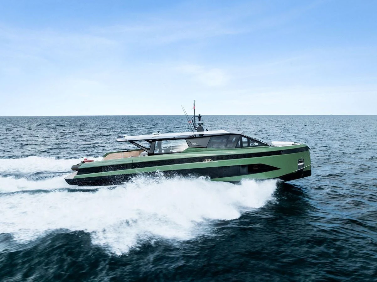 A sleek yacht cruises swiftly across open waters under a clear sky. aboard ANOTHER WORLD Yacht for Sale