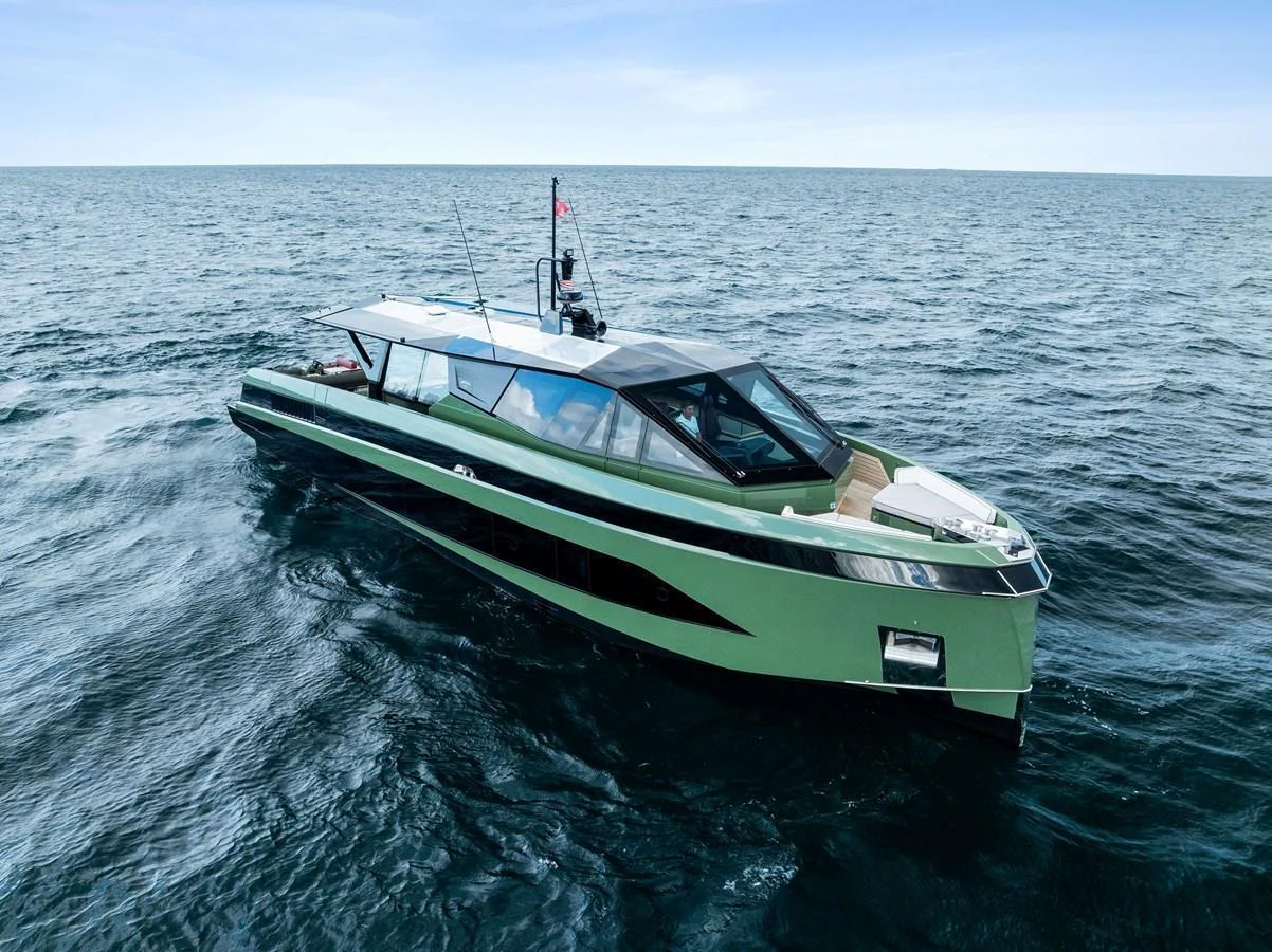 A sleek, modern yacht glides effortlessly on the open sea under a clear blue sky. aboard ANOTHER WORLD Yacht for Sale