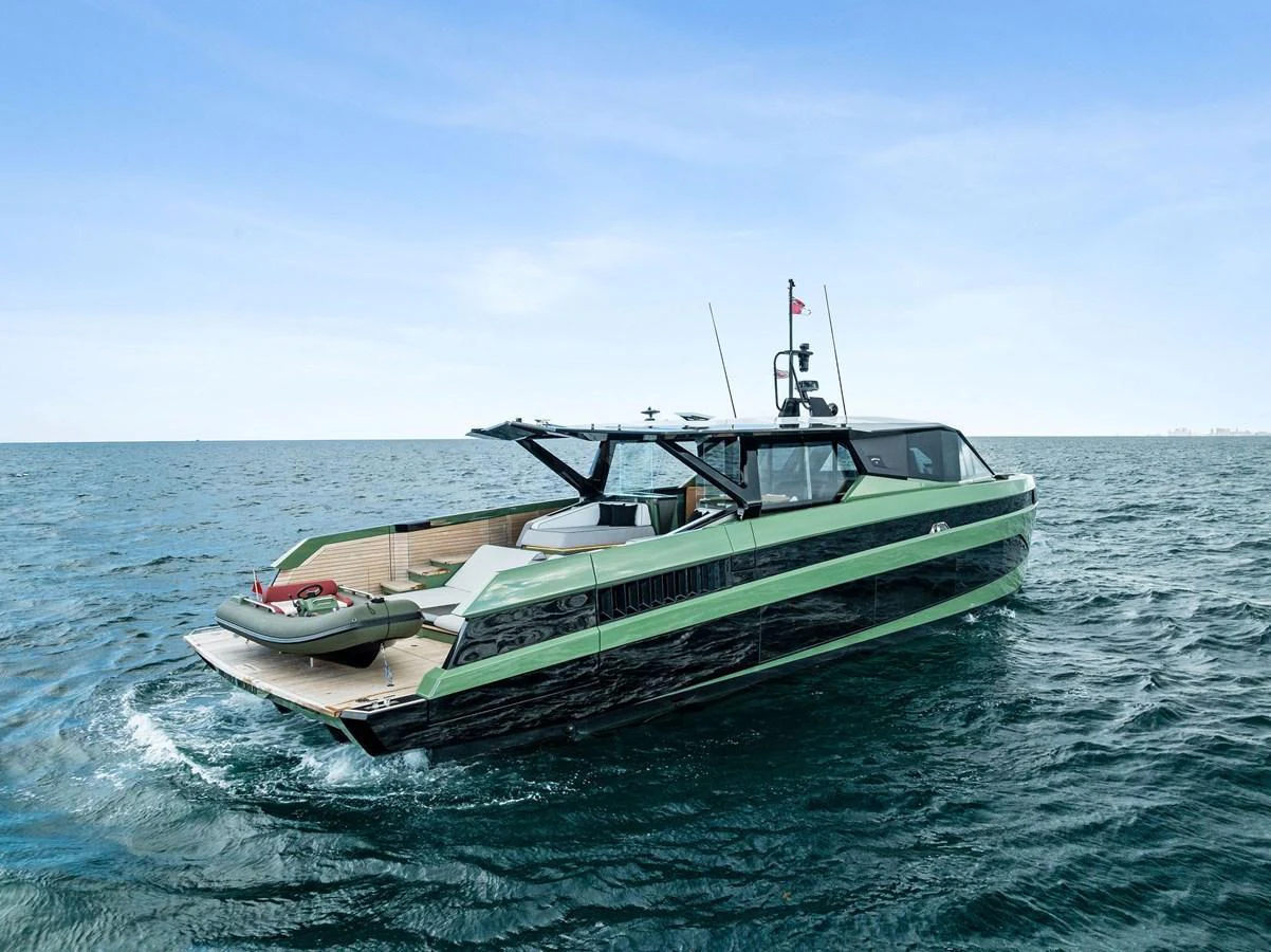 A sleek yacht cruises on open water under a clear blue sky. aboard ANOTHER WORLD Yacht for Sale