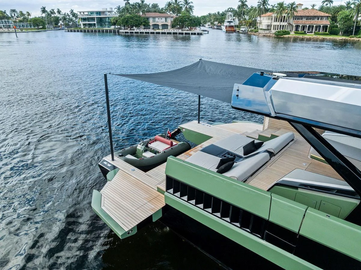 The aft deck of the yacht features a spacious lounging area with a retractable canopy, perfect for relaxation by the water. aboard ANOTHER WORLD Yacht for Sale