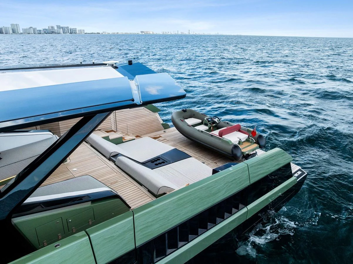 The yacht's aft deck features a sleek design with a tender ready for adventure. aboard ANOTHER WORLD Yacht for Sale