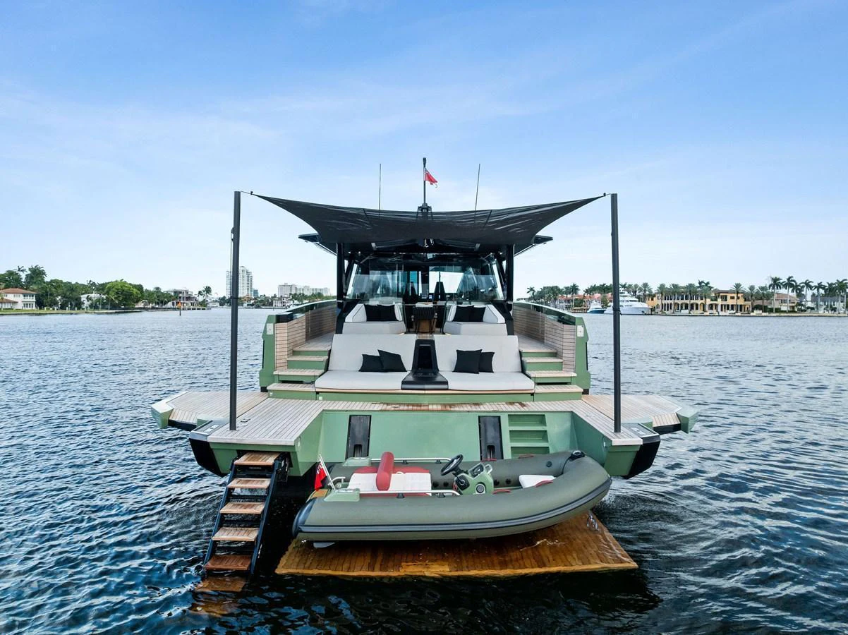 The yacht's aft deck features a spacious lounging area and a tender on the swim platform. aboard ANOTHER WORLD Yacht for Sale