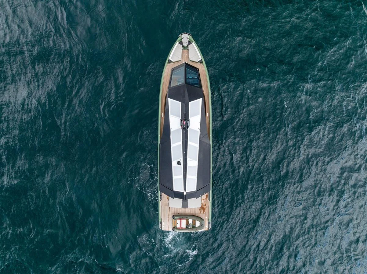 A sleek yacht is captured from an aerial view, showcasing its modern design and clean lines as it cruises through the water. aboard ANOTHER WORLD Yacht for Sale