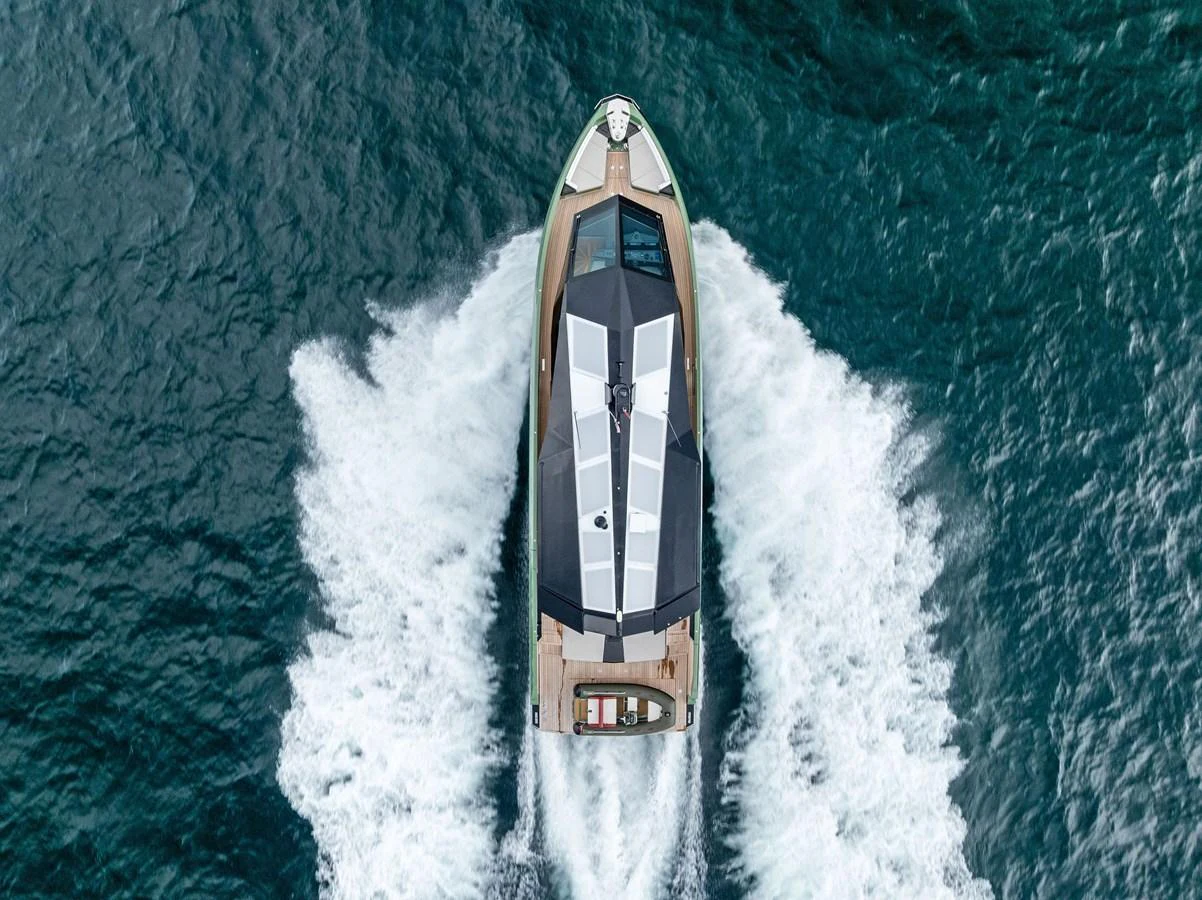 A sleek yacht cruises through the water, leaving a trail of white wake behind. aboard ANOTHER WORLD Yacht for Sale