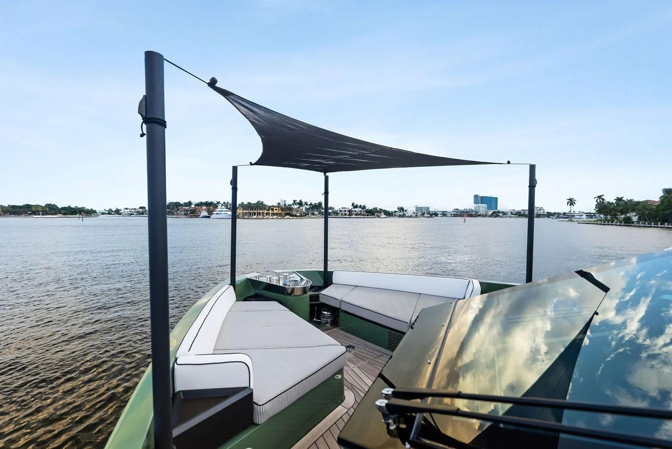 The yacht's deck features a stylish lounging area with a canopy providing shade and comfort. aboard ANOTHER WORLD Yacht for Sale