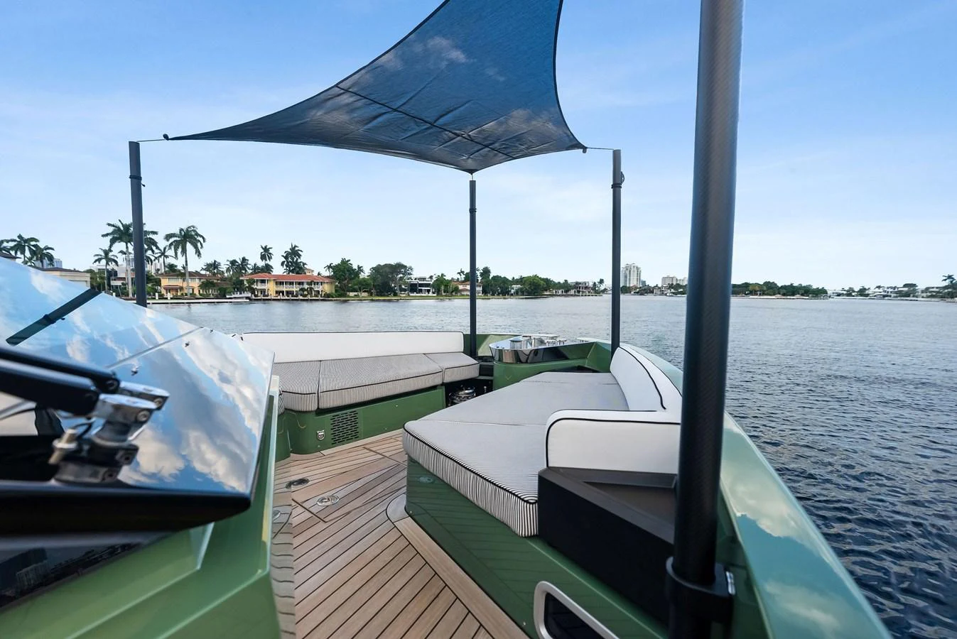 The aft deck features a comfortable seating area with a shade canopy, perfect for enjoying scenic views on the water. aboard ANOTHER WORLD Yacht for Sale