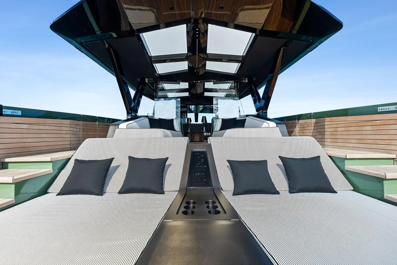 The sundeck features luxurious sun loungers with plush cushions under a sleek canopy. aboard ANOTHER WORLD Yacht for Sale