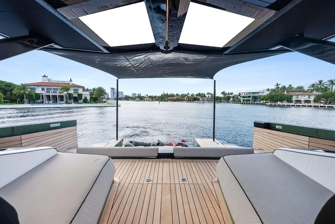 The aft deck offers a serene view of the water, framed by luxurious seating and a sleek design. aboard ANOTHER WORLD Yacht for Sale