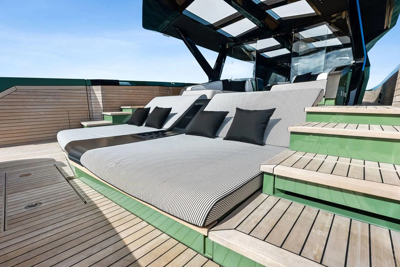The sundeck features luxurious sun loungers with plush cushions and a sleek, modern design. aboard ANOTHER WORLD Yacht for Sale