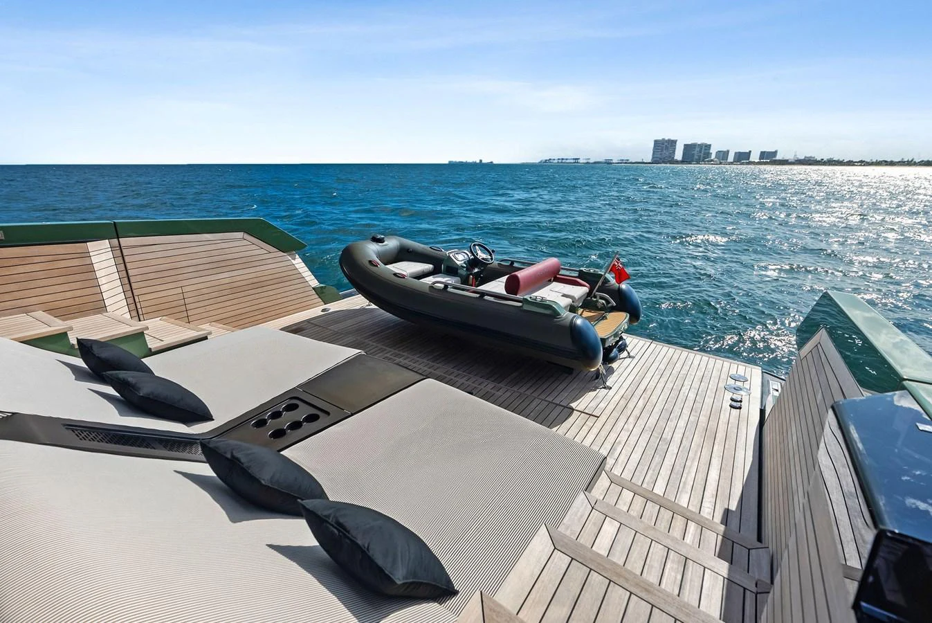 The aft deck features a luxurious lounging area with a tender ready for adventure. aboard ANOTHER WORLD Yacht for Sale