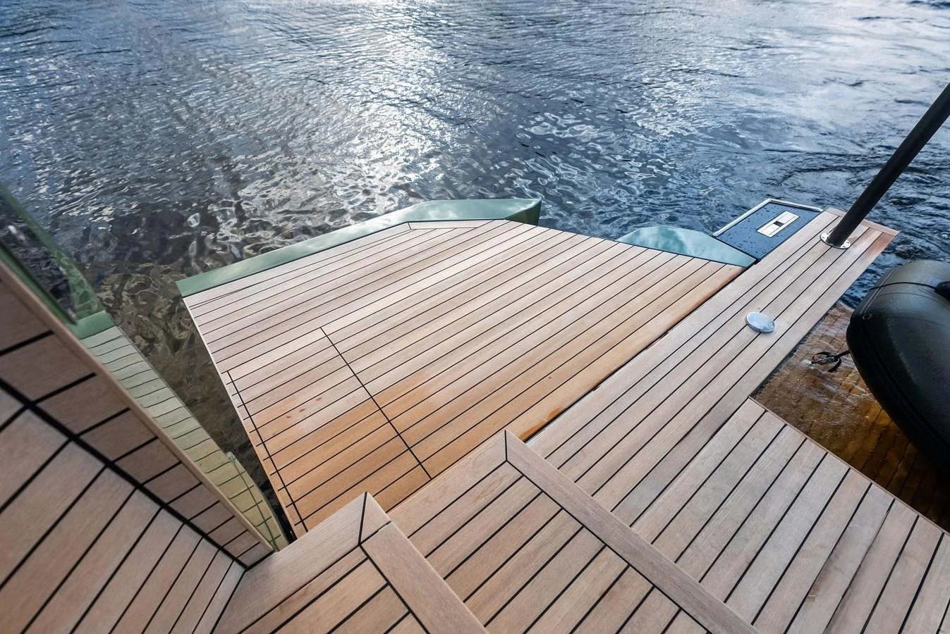 The yacht features a sleek and modern swim platform with elegant wooden decking, perfect for easy water access. aboard ANOTHER WORLD Yacht for Sale