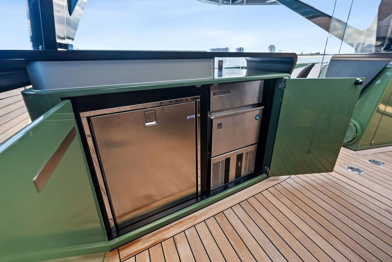 The image showcases a built-in stainless steel refrigerator and storage unit on the yacht's deck. aboard ANOTHER WORLD Yacht for Sale