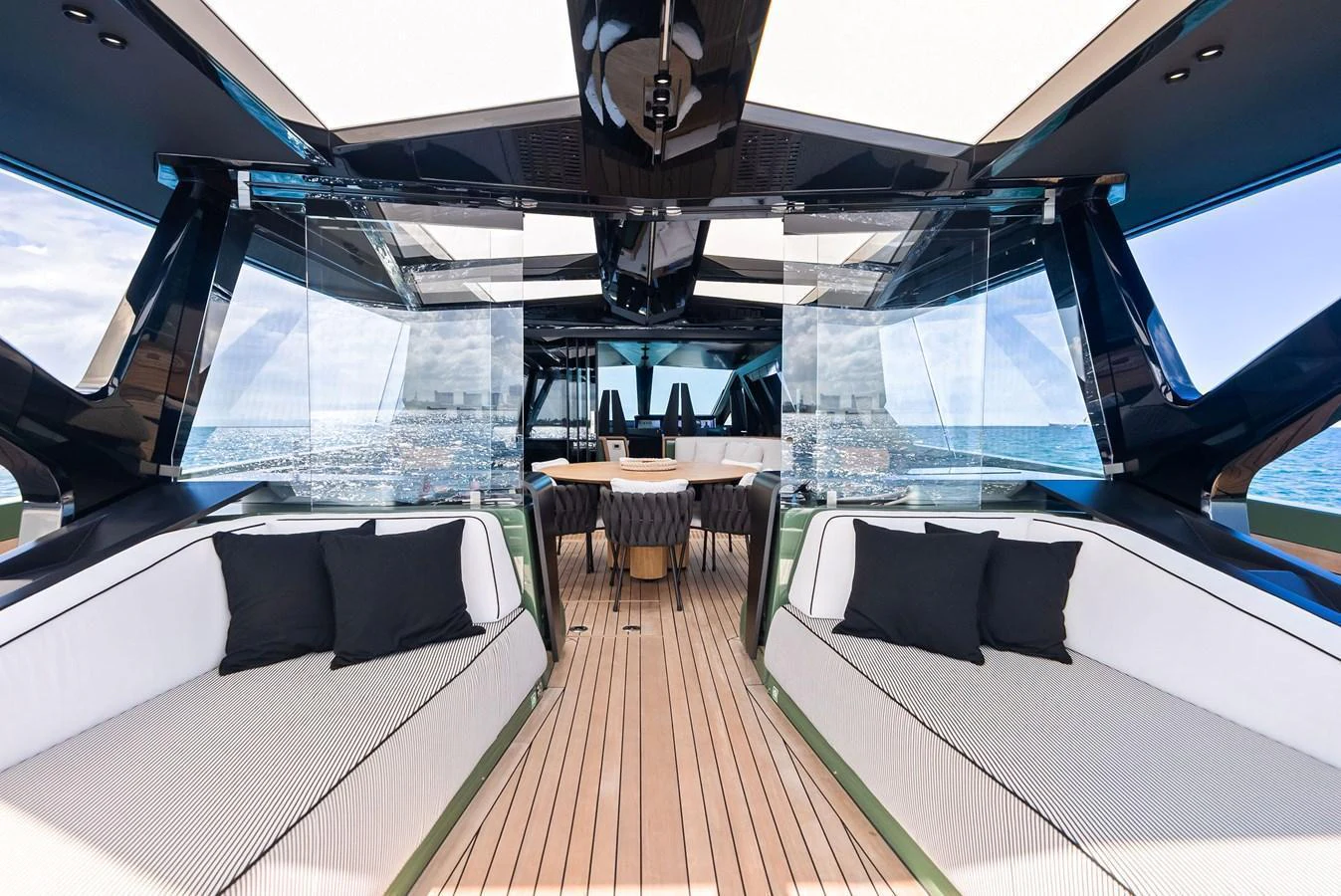 The aft deck features a spacious seating area with modern furnishings and panoramic views. aboard ANOTHER WORLD Yacht for Sale