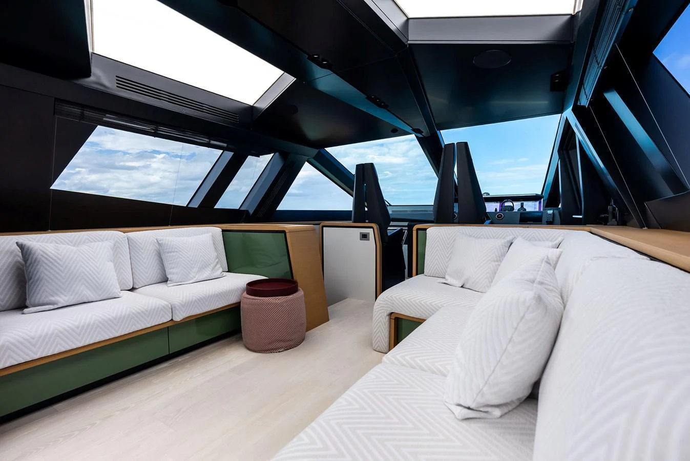 The salon features modern furnishings with ample natural light from large windows and skylights. aboard ANOTHER WORLD Yacht for Sale