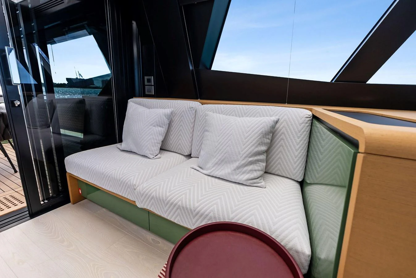 The yacht's salon features a comfortable seating area with plush cushions and modern decor. aboard ANOTHER WORLD Yacht for Sale