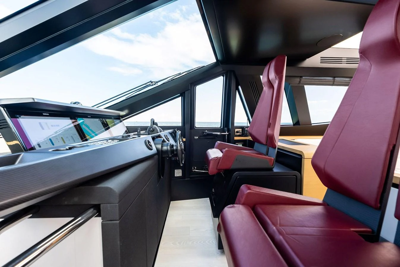 The helm station features modern controls and luxurious seating with panoramic views. aboard ANOTHER WORLD Yacht for Sale