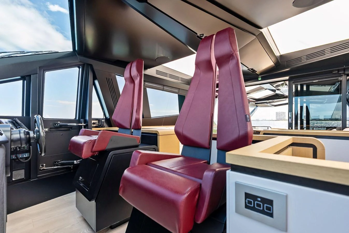 The helm station features sleek, modern seating with panoramic views. aboard ANOTHER WORLD Yacht for Sale
