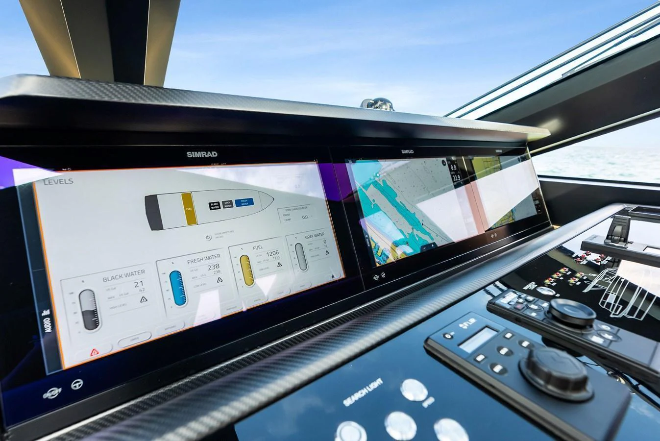 The helm station features advanced navigation and control systems with sleek, modern displays. aboard ANOTHER WORLD Yacht for Sale