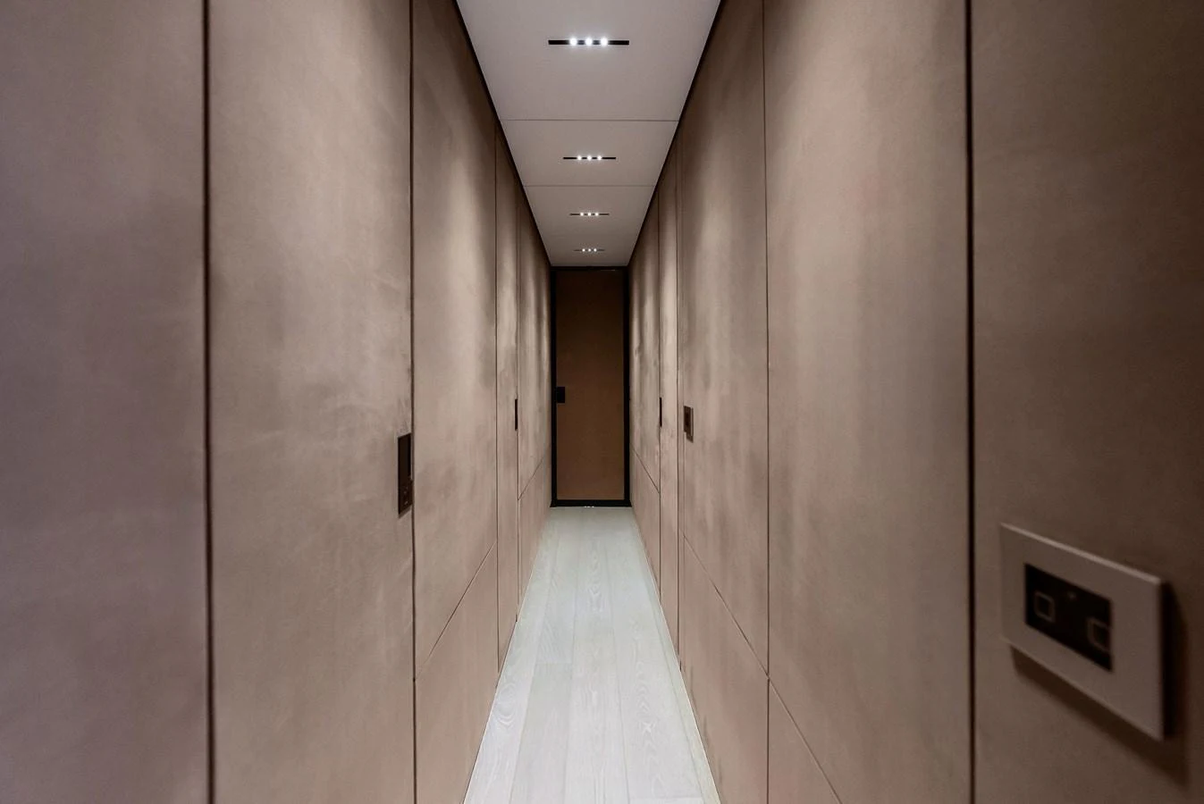 A sleek and modern hallway with minimalist design and recessed lighting. aboard ANOTHER WORLD Yacht for Sale