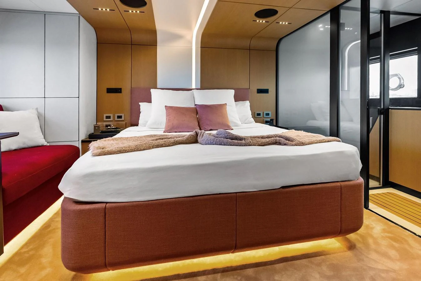 A luxurious stateroom featuring a plush bed with modern decor and ambient lighting. aboard ANOTHER WORLD Yacht for Sale