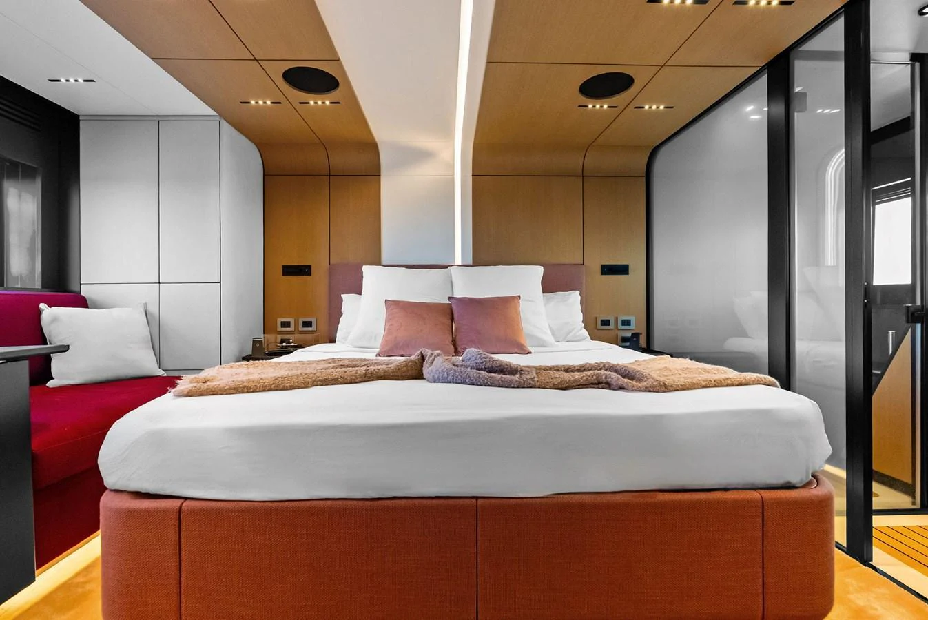 The stateroom features a luxurious bed with modern decor and ample natural light. aboard ANOTHER WORLD Yacht for Sale