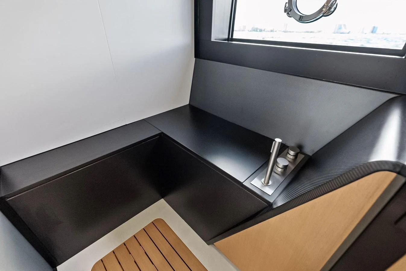 A sleek and modern interior corner with a window and minimalist design. aboard ANOTHER WORLD Yacht for Sale