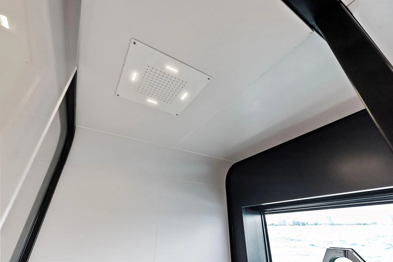 A sleek and modern interior space with a large window offering a view of the water. aboard ANOTHER WORLD Yacht for Sale