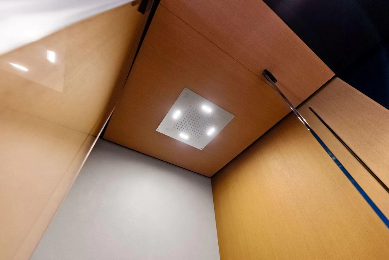 A modern shower area with a sleek ceiling-mounted showerhead and recessed lighting. aboard ANOTHER WORLD Yacht for Sale