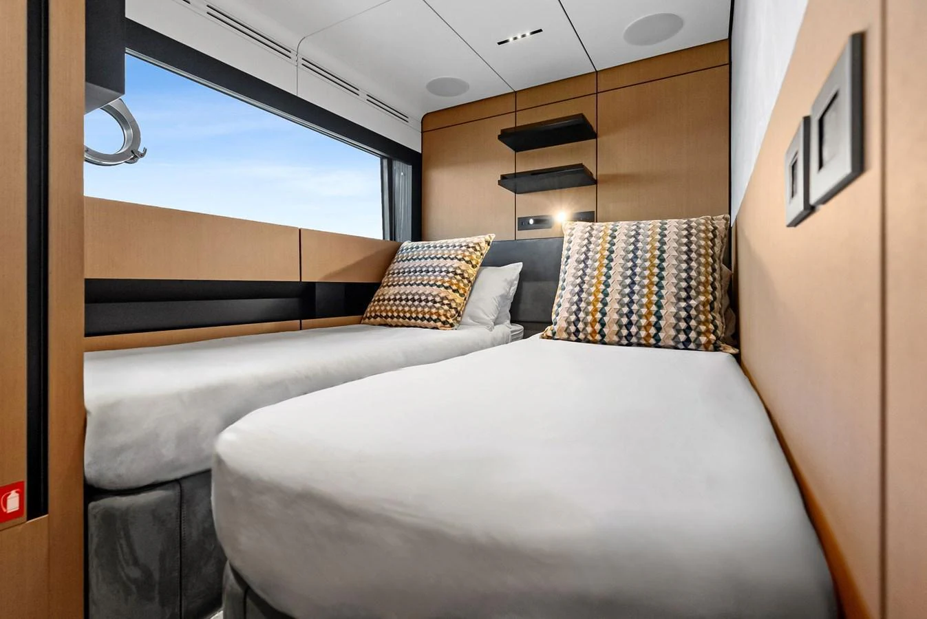 The guest cabin features twin beds with modern decor and ample natural light. aboard ANOTHER WORLD Yacht for Sale