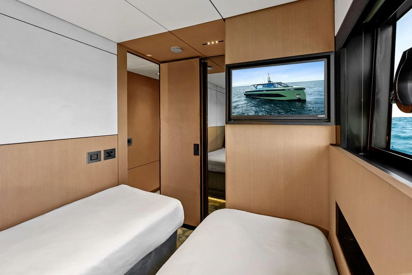The guest cabin features twin beds and a window with a view of the sea. aboard ANOTHER WORLD Yacht for Sale