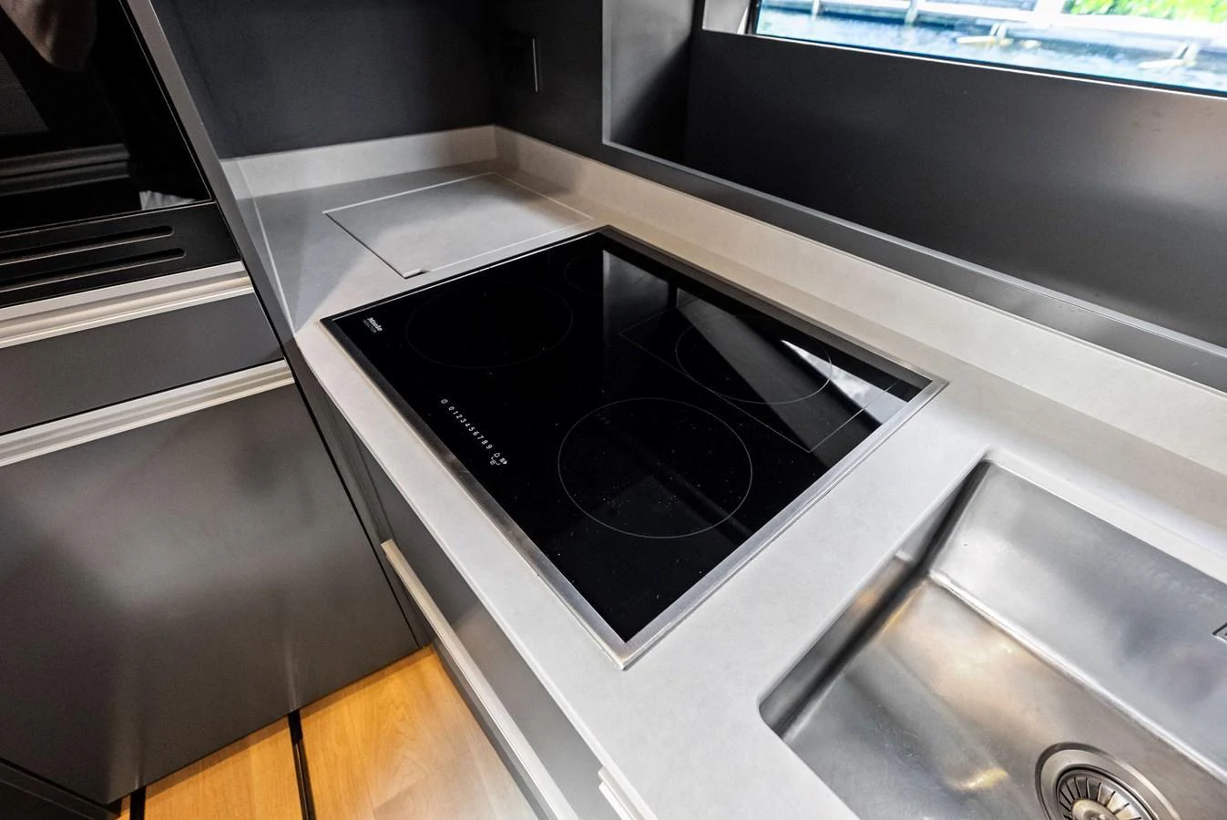 The sleek galley features a modern induction cooktop and stainless steel sink, perfect for gourmet meal preparation. aboard ANOTHER WORLD Yacht for Sale