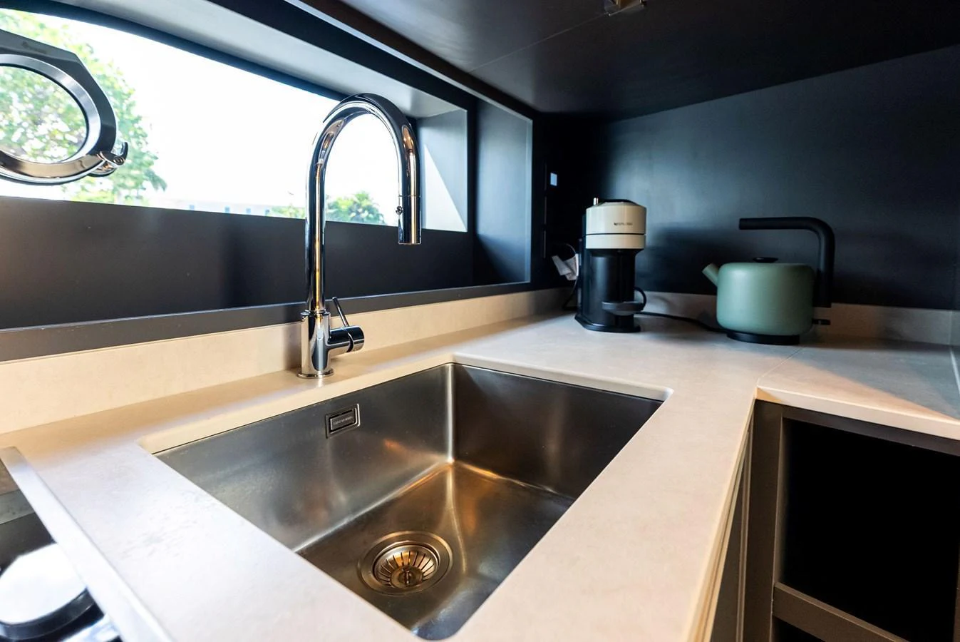 The yacht's galley features a sleek, modern sink area with high-end fixtures and appliances. aboard ANOTHER WORLD Yacht for Sale
