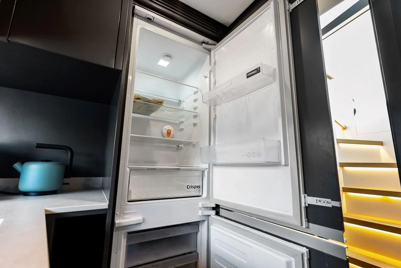 The galley features a modern refrigerator with ample storage space. aboard ANOTHER WORLD Yacht for Sale