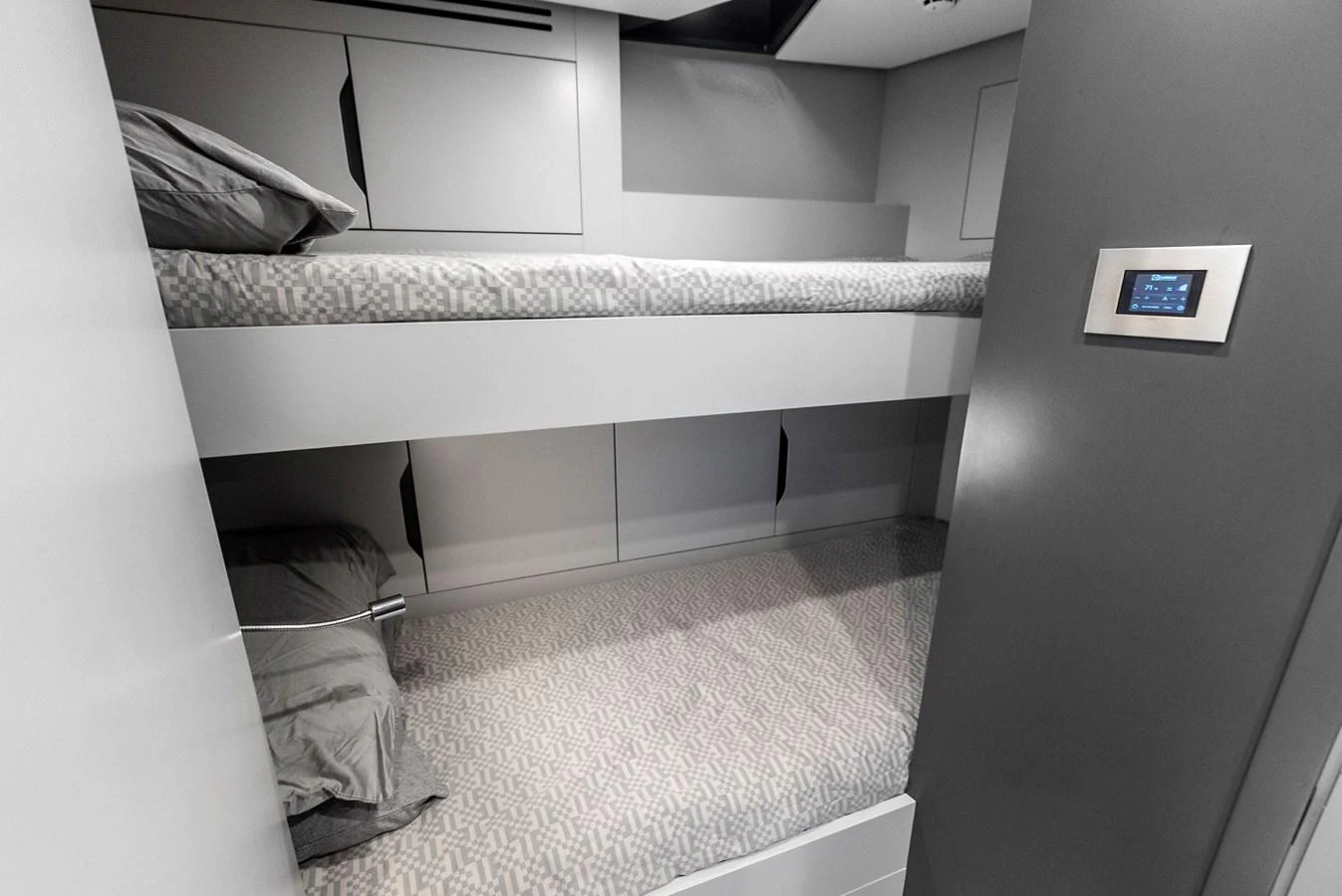 The yacht features a cozy bunk cabin with modern design and comfortable bedding. aboard ANOTHER WORLD Yacht for Sale