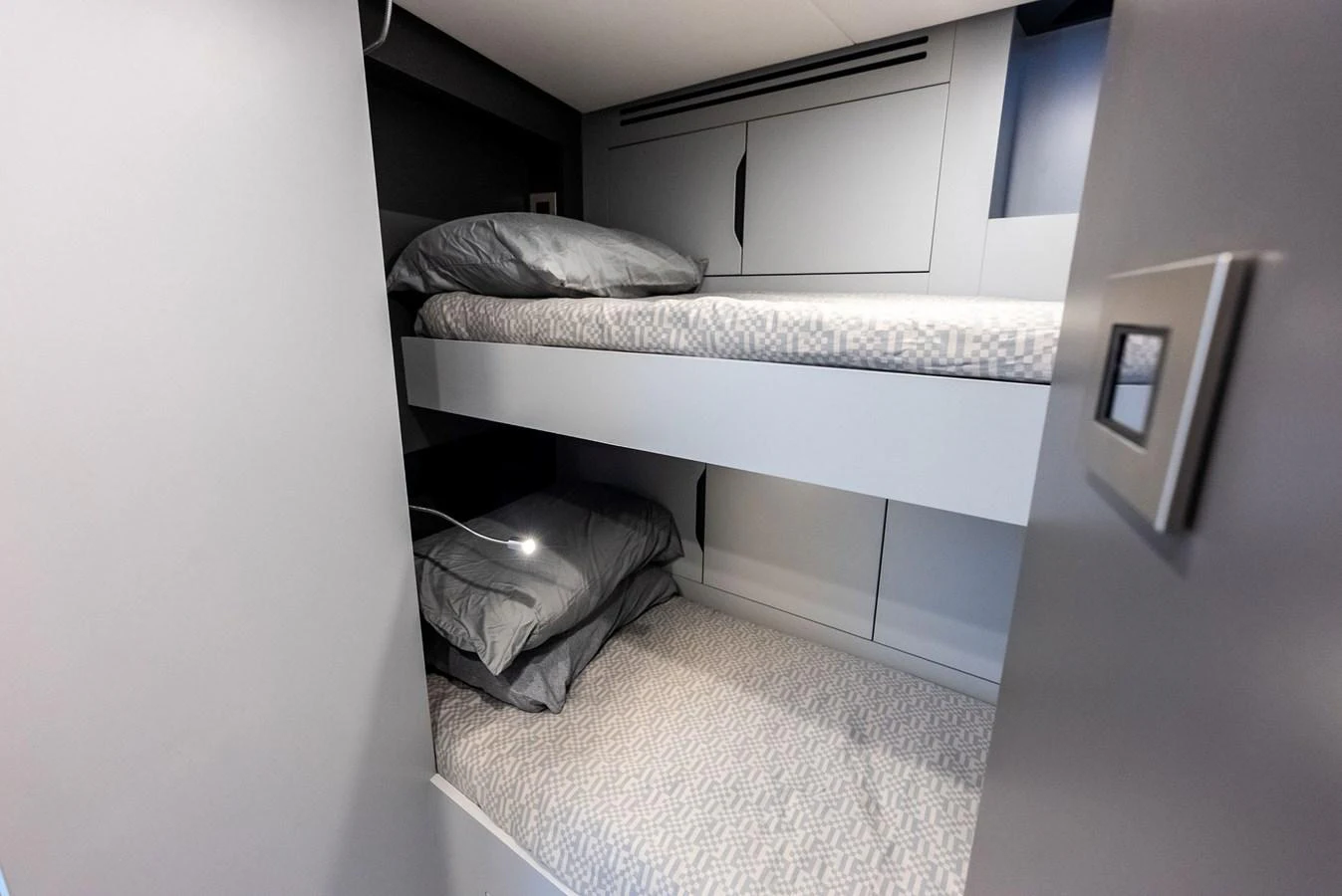 A cozy bunk cabin with modern design and soft lighting. aboard ANOTHER WORLD Yacht for Sale
