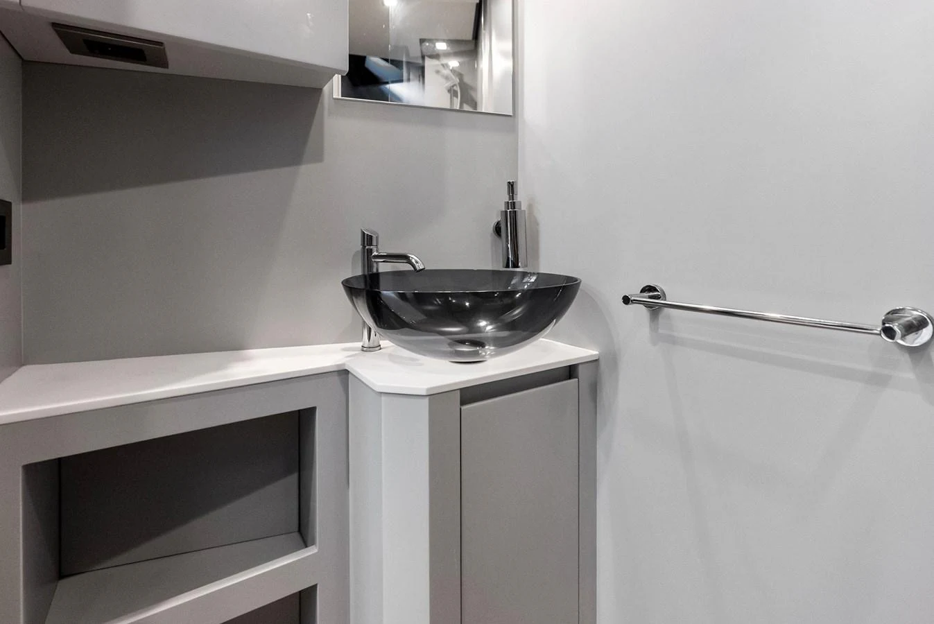 A sleek and modern yacht bathroom featuring a stylish glass sink and minimalist design. aboard ANOTHER WORLD Yacht for Sale