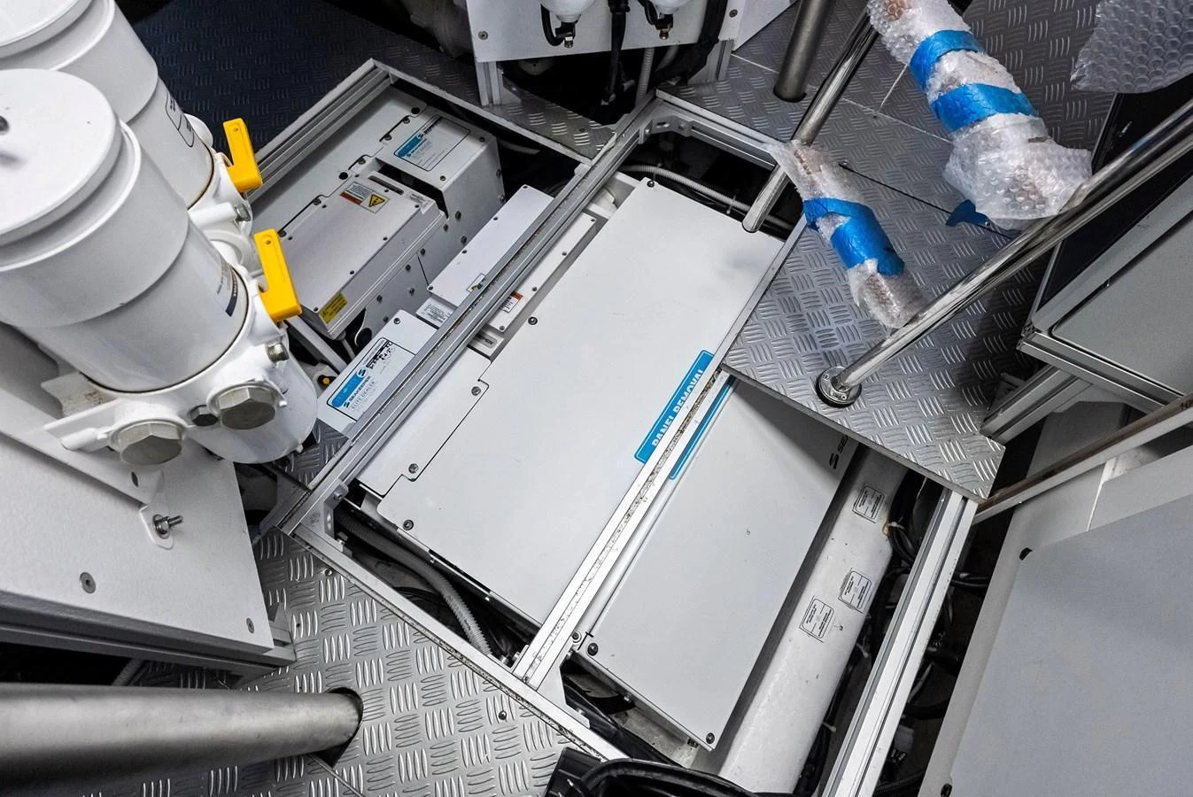 The image showcases the technical components and machinery within the yacht's engine room. aboard ANOTHER WORLD Yacht for Sale