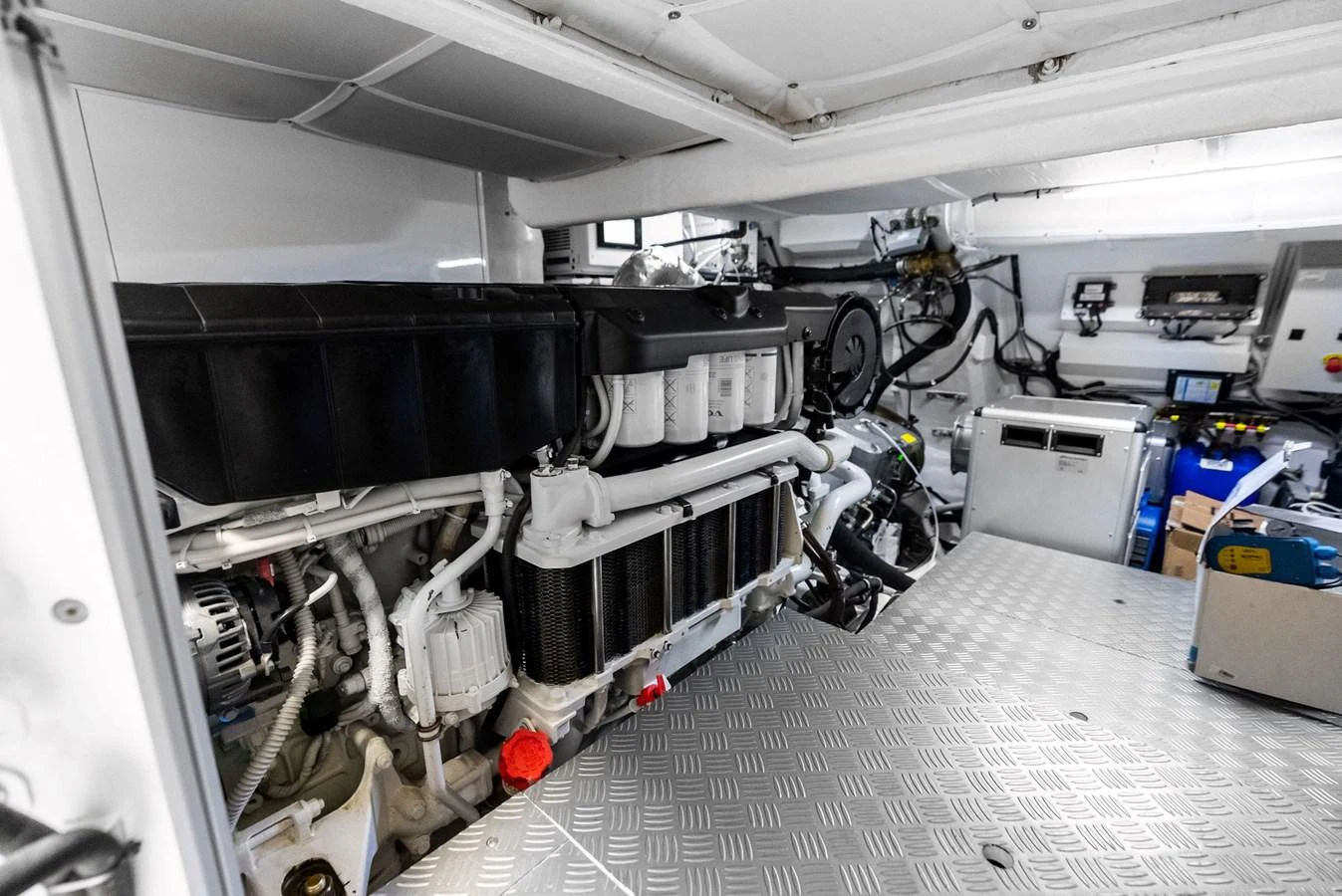 The image showcases the well-organized and clean engine room of the yacht, highlighting its mechanical components. aboard ANOTHER WORLD Yacht for Sale
