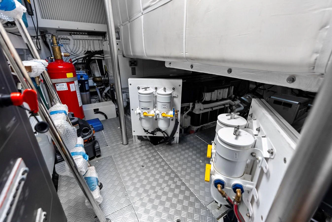 The image showcases the yacht's engine room with various mechanical components and equipment. aboard ANOTHER WORLD Yacht for Sale