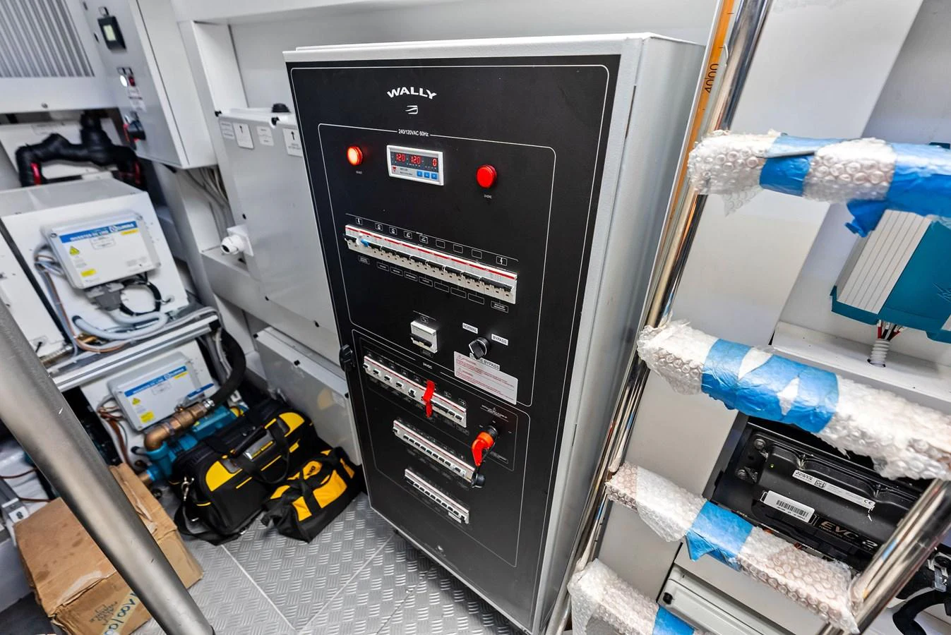 The image showcases the yacht's electrical control panel in a well-organized technical room. aboard ANOTHER WORLD Yacht for Sale