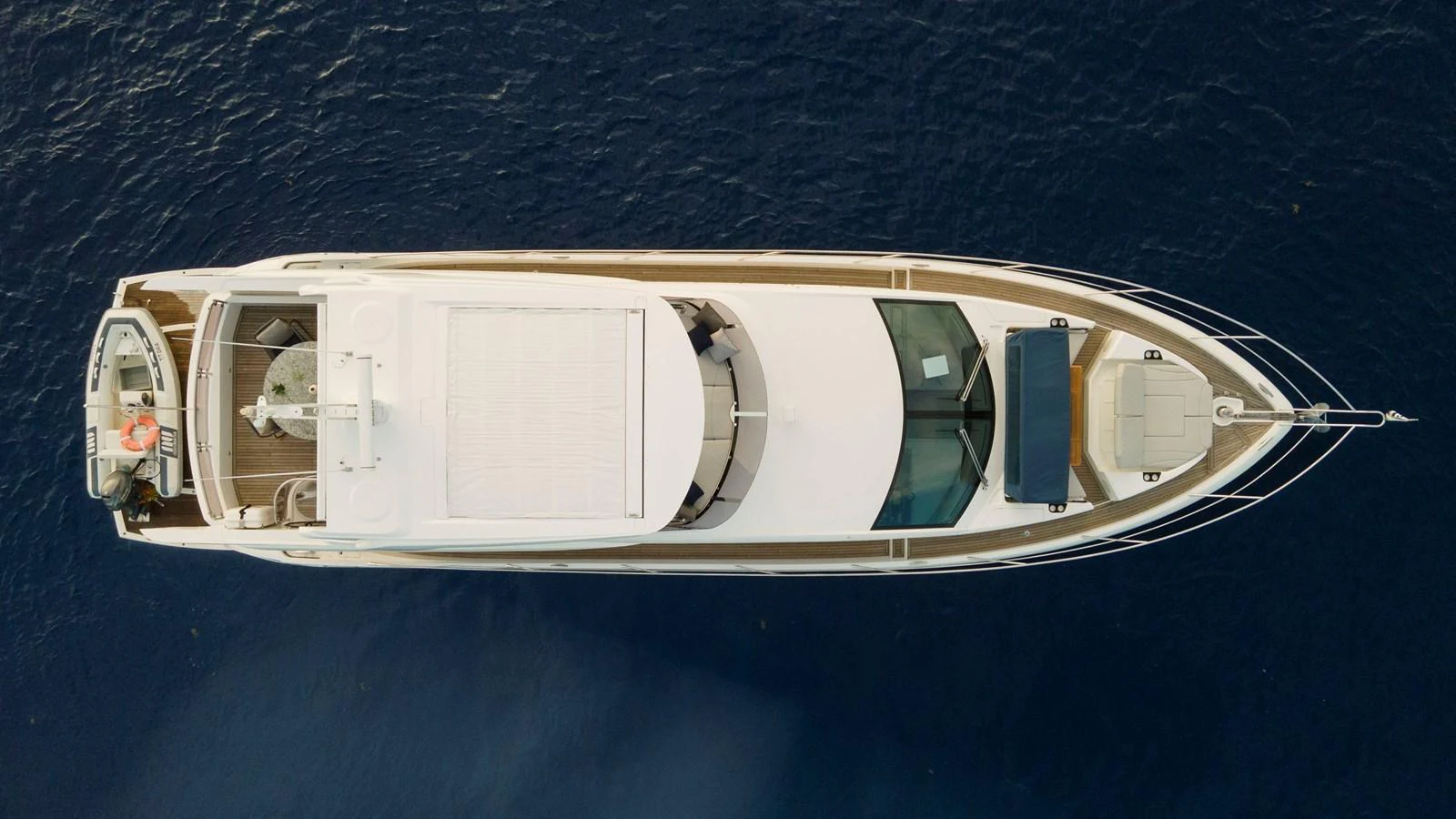 An aerial view of a sleek yacht cruising on calm waters. aboard GAIA Yacht for Sale