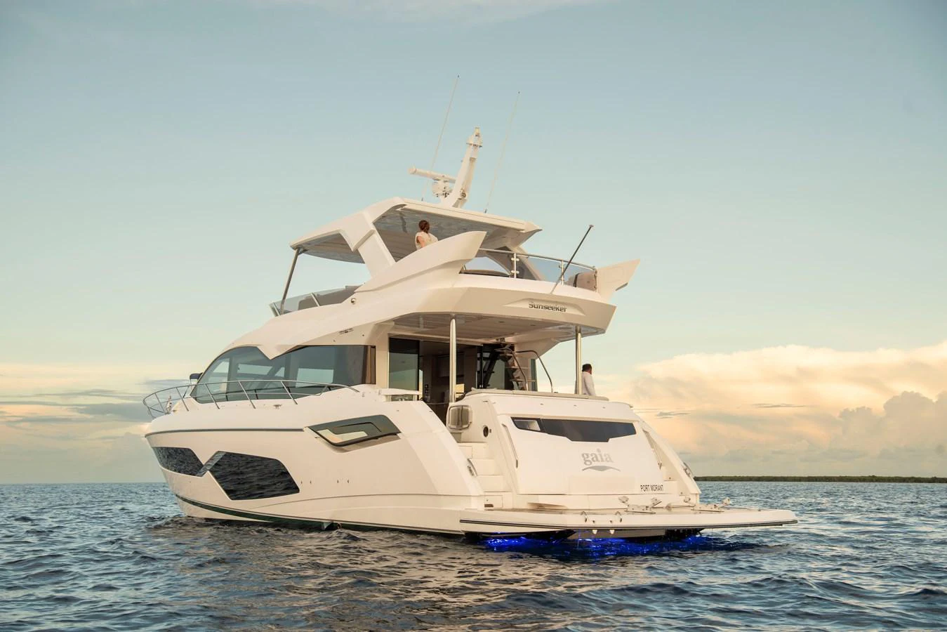 A luxurious yacht cruising on calm waters under a serene sky. aboard GAIA Yacht for Sale