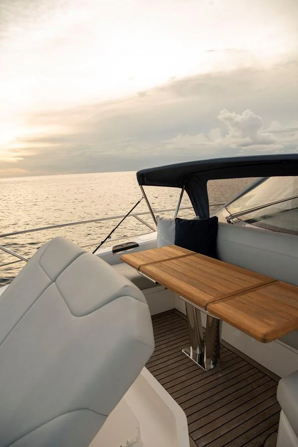 The aft deck offers a serene setting with comfortable seating and a wooden table, perfect for enjoying the ocean view. aboard GAIA Yacht for Sale