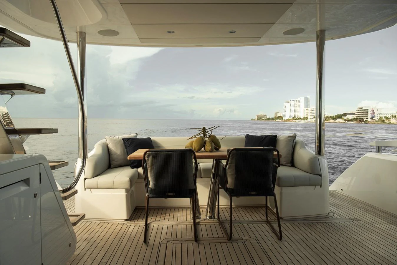 The aft deck features a stylish dining area with comfortable seating and a scenic view of the water. aboard GAIA Yacht for Sale