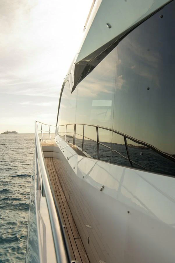 The sleek exterior of the yacht reflects the serene ocean and sky. aboard GAIA Yacht for Sale