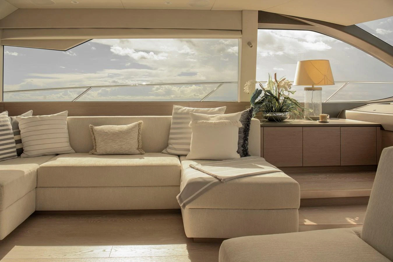 The salon features a comfortable seating area with large windows offering a panoramic view. aboard GAIA Yacht for Sale